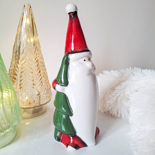 Red Santa Holding Christmas Tree
