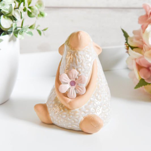 Sitting Sheep with Flower Ornament