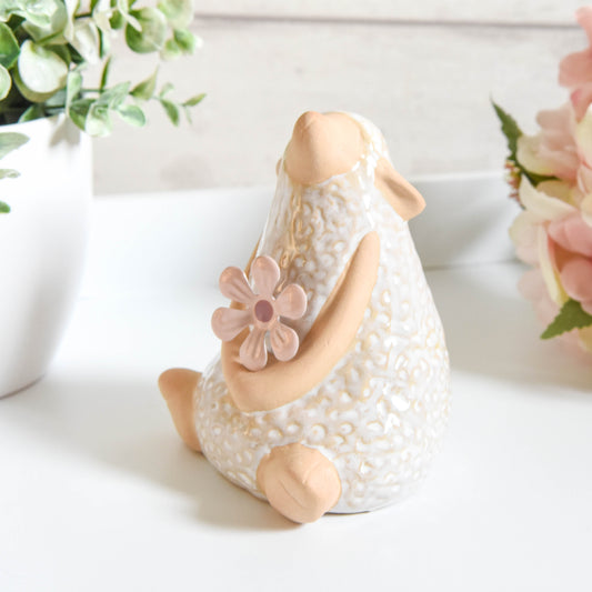 Sitting Sheep with Flower Ornament